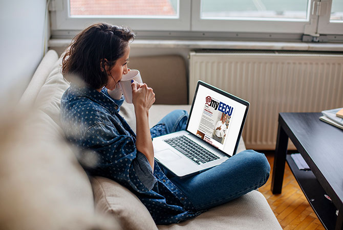 Women drinking coffee and reading newsletter on a laptop