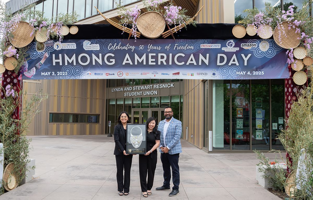 EECU management holding award with Hmong community representative